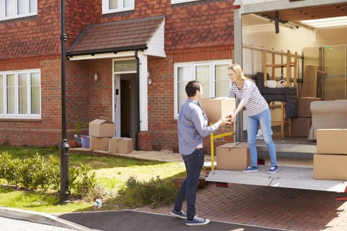 Moving crew navigating stairs and apartment access in Westminster
